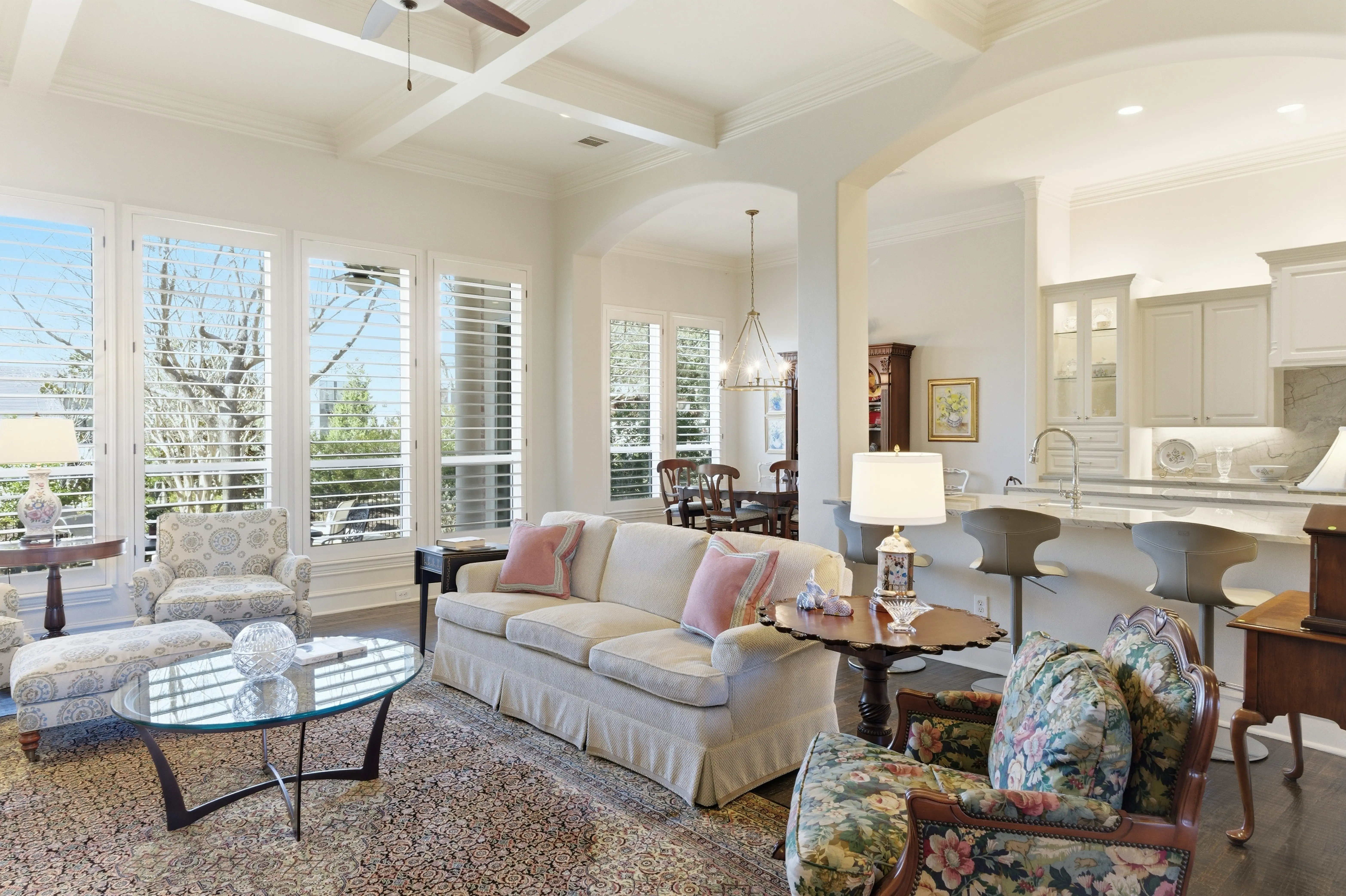 Living room seating area with hardwood floors and natural light